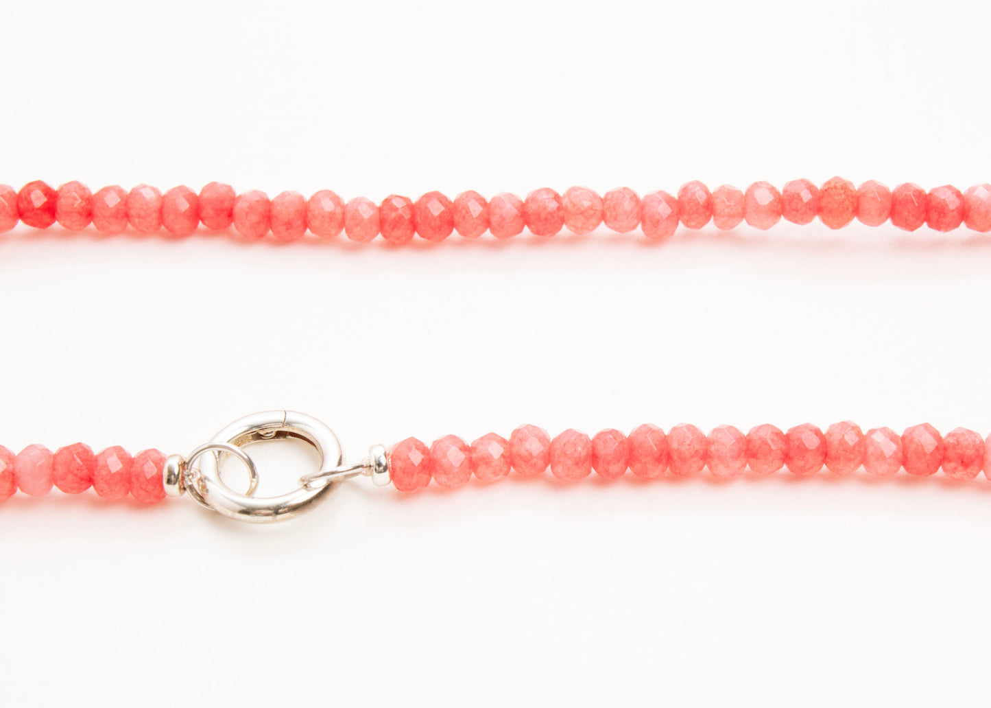 Front_view_detail_of_a closed rose_small_quartzite_bead_strand_placed horizontally on a white background