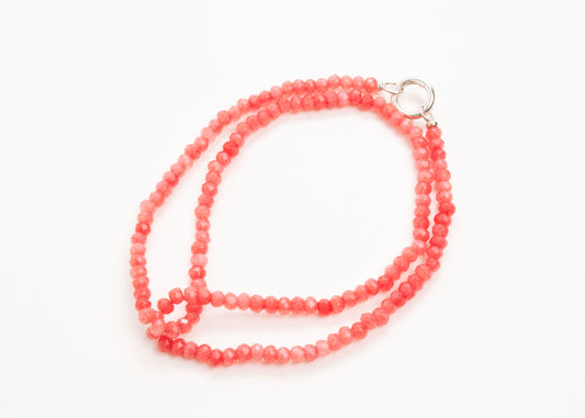 Plan view of a closed rose_small_quartzite_bead strand_wrapped_in_two_loops_on a white background