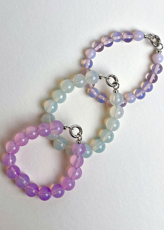 Overhead view of 3 Opalite beaded chainlets with looped Sterling Silver endings closed with connector on a white background