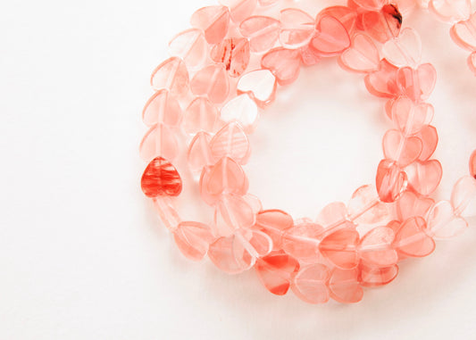 Plan view of a Cherry Quartz heart bead necklace on a white background 