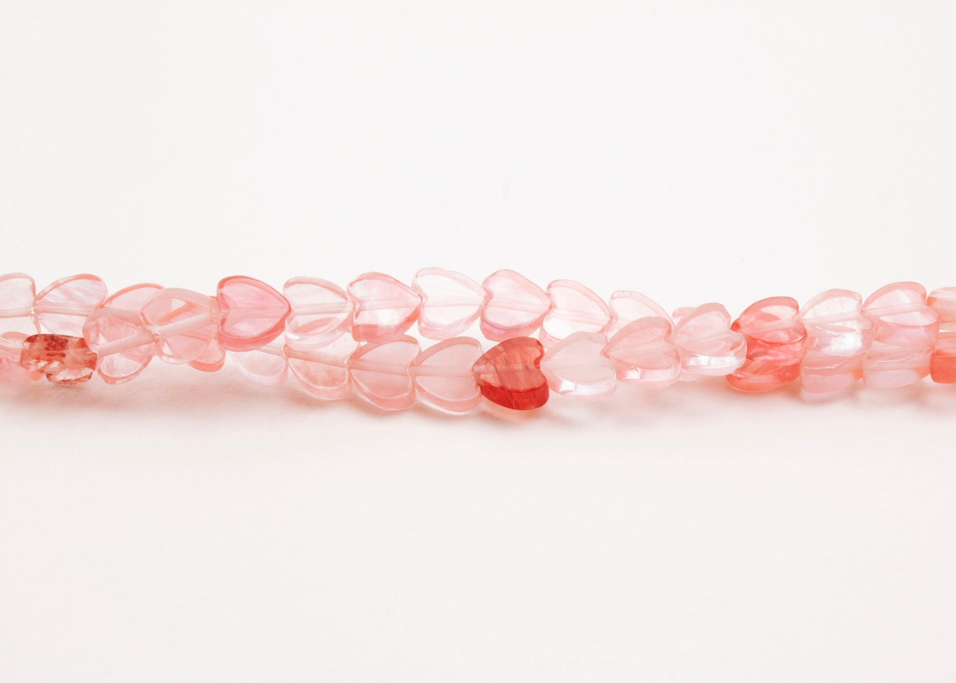 Front horizontal view of Cherry Quartz heart bead necklace on a white background 