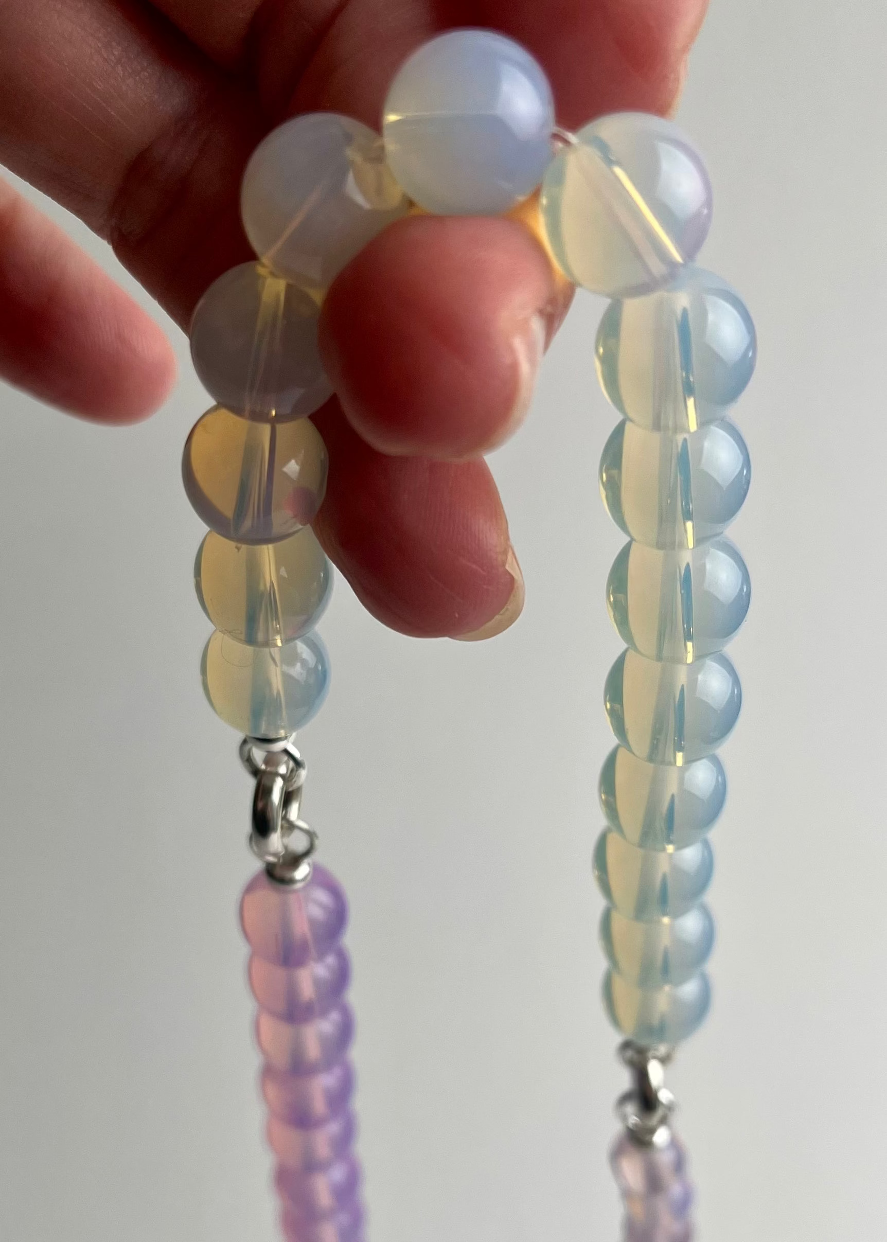 Close up bead detail of an Opalite necklace made of three chainlets in three different colours