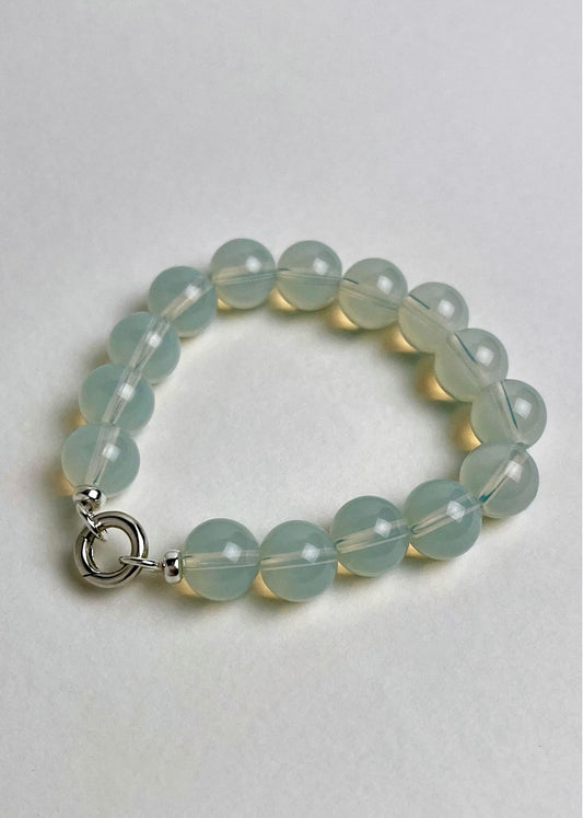 Front view of a grey-blue Opalite beaded chainlet with looped Sterling Silver endings closed with a connector on a white background