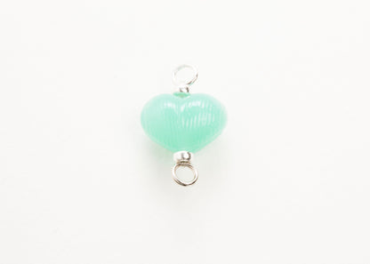 Front plan view of mint glass heart charm placed on white background.