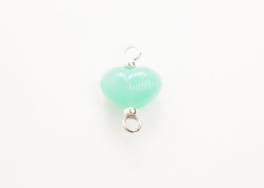 Front plan view of mint glass heart charm placed on white background.