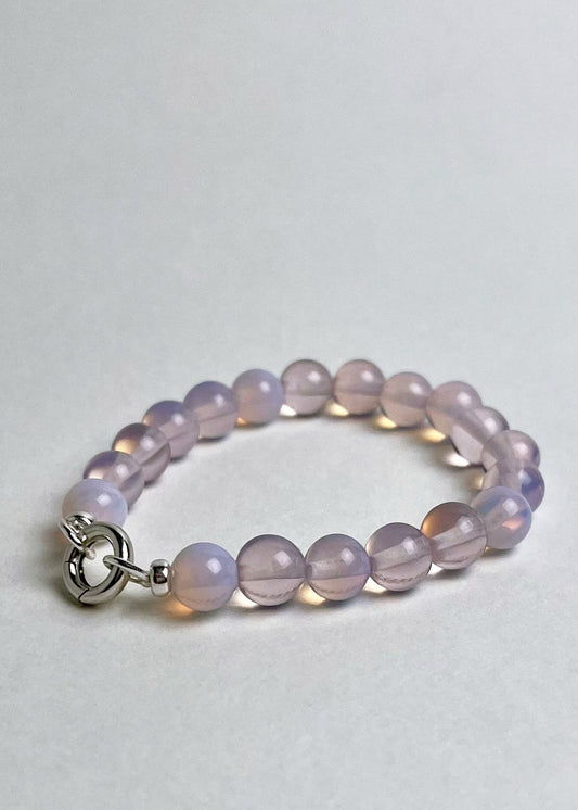 Front view of a peach-pink Opalite beaded chainlet with looped Sterling Silver endings closed with connector on a white background