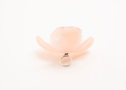 Full back close up of a peach resin_flower charm with lavender glass beads detail_and a Sterling Silver looped ending on a white background.
