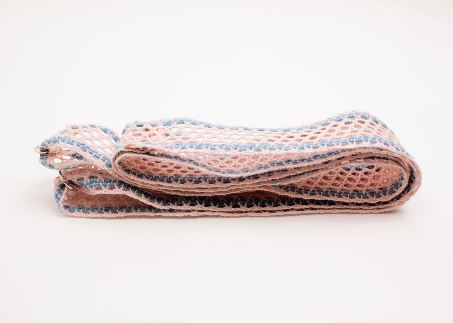 Front side view of a folded cotton fishnet ribbon in pink and light blue with Sterling Silver looped endings on a white background