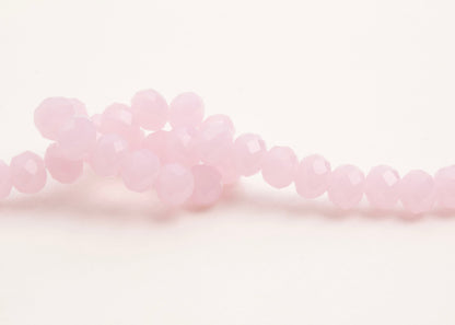 Front_view of a pink_rondelles_glass_bead_strand_knotted_on a white background.