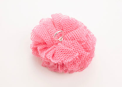 Back view of a rose point de tulle flower charm with Sterling Silver ending on a white background