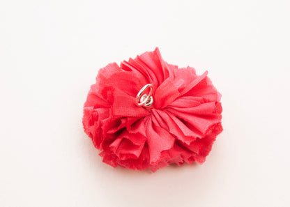 Rich pink flower connector and charm with pearled white glass bead trio in the centre on a white background.