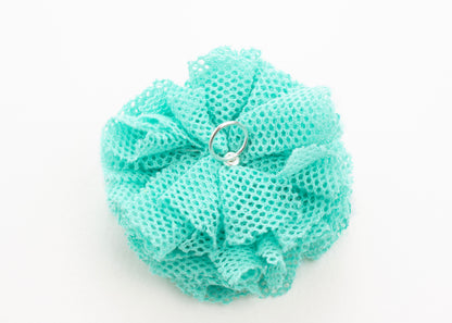 Back view of a turquoise point de tulle flower charm with Sterling Silver ending on a white background