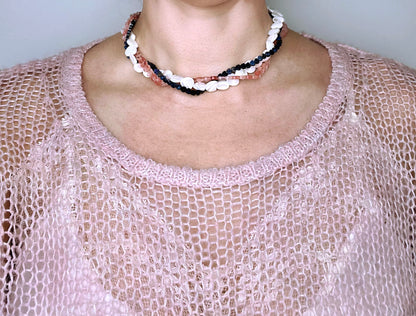 Front view of a woman wearing layered necklaces made out of Mop, Lapis lazuli and cherry quartz gemstone heart beads
