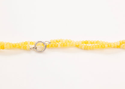 yellow_small_quartzite_beads_strand_drop_twisted_horizontal_view_closed_close_up