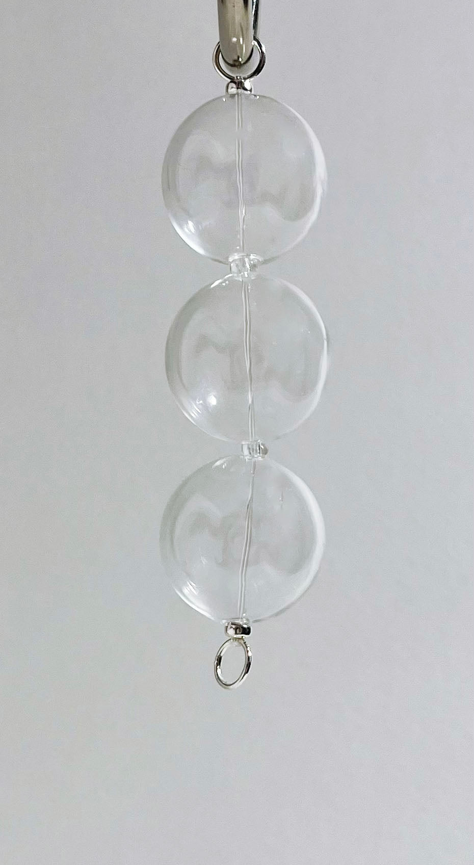 Front view of a chunky glass beaded chainlet strand with Sterling Silver endings hanging from metal hook to appreciate drop