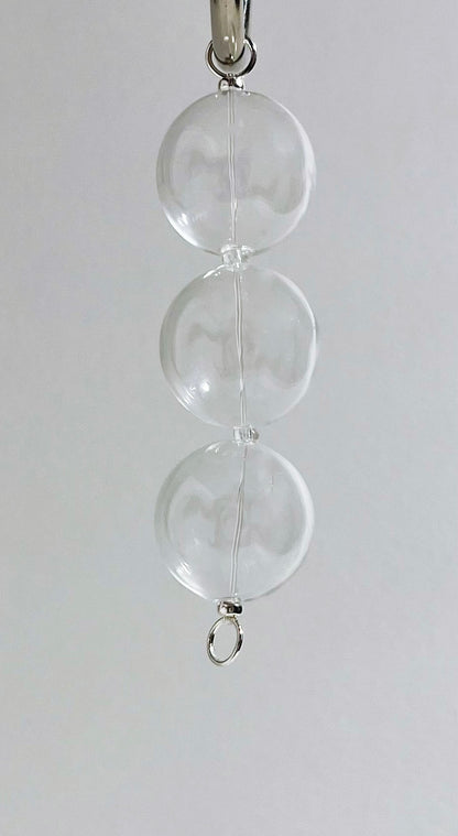 Front view of a chunky glass beaded chainlet strand with Sterling Silver endings hanging from metal hook to appreciate drop