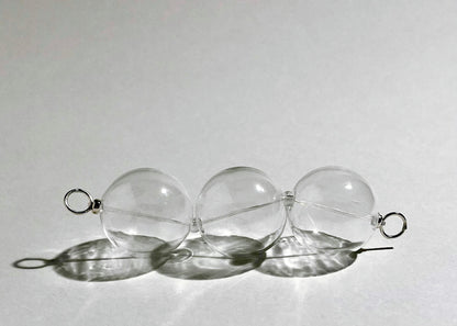 Front view of a chunky clear glass beaded chainlet with Sterling Silver lopped endings on hard light on a white background